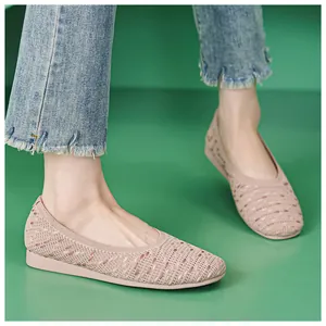 Detail of light pink knit flat shoes with breathable mesh and comfortable round toe