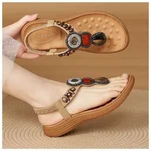 Detail of bohemian wedge sandals featuring colorful gemstones and wooden bead accents