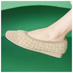 Macro detail of beige fuzzy knit flat shoes with elegant diamond textured pattern