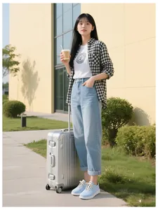 Street style fashion featuring a Medusa logo T-shirt and light blue straight jeans