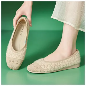 Detail of beige knit flats featuring plush lining and geometric textured design for women