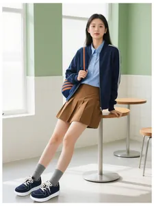 Casual preppy style outfit with navy zip-up jacket and blue shirt with pleated skirt