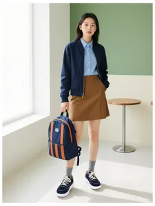 Deep blue casual backpack with orange stripes shown in an urban fashion ensemble