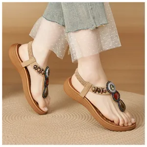 Detail of bohemian T-strap sandals with vintage beads and large crystal embellishments