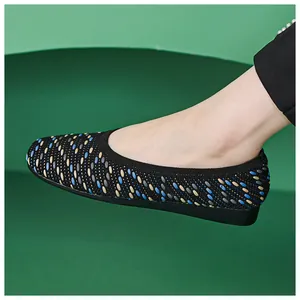 Detail of breathable knitted flat shoe featuring a textured tri-color woven pattern
