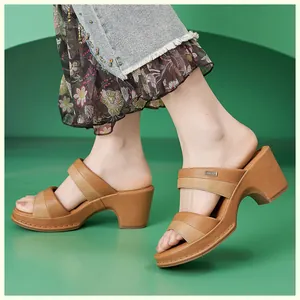 Detail view of brown color-block wedge mule sandals with thick soles and decorative stitching