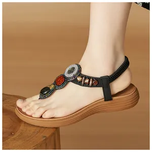 Detail of bohemian wedge sandals featuring ethnic beads and a textured wood-grain sole