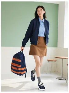 Fashionable lifestyle look with navy canvas sneakers, pleated skirt, and a matching backpack