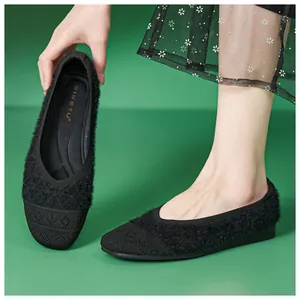 Detail of black faux fur and knit patchwork women's flat shoe with soft cushioned insole