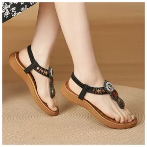Detail of bohemian wedge sandals featuring vintage beads, gemstones, and elastic heel straps