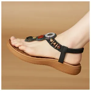 Detail of Bohemian T-strap sandals featuring colorful beads and elastic heel strap