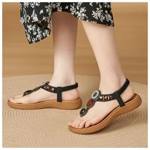 Detail of Bohemian flat sandals featuring colorful beads, sequins and elastic back strap