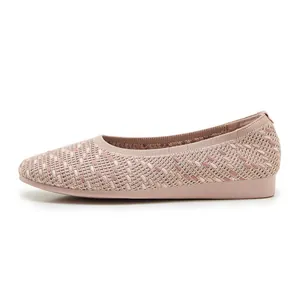 Detailed close-up of knit fabric texture on light pink comfortable flat ballet shoes