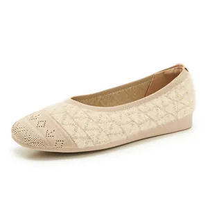Detail of beige knit ballet flats featuring plush fabric and quilted texture patterns