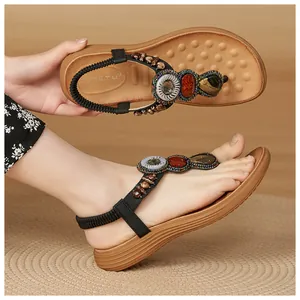 Close-up of bohemian sandals with colorful beads, resin stones and elastic heel strap