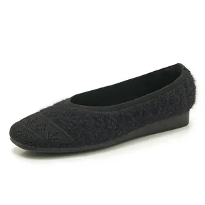 Detailed macro view of black knit flat shoe with geometric diamond pattern texture