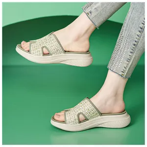 Detail van beige gevlochten plateausandalen met strass en antislipzool met honingraatpatroon