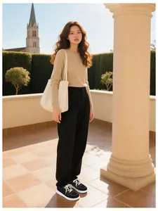 Black and white casual sneakers styled with black wide-leg trousers on a model