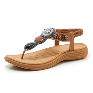 Detail of bohemian wedge sandal featuring intricate beadwork and colorful decorative gemstones