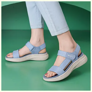 Vue latérale de sandales compensées bleu clair avec brides velcro portées en studio