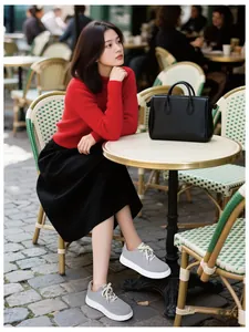 Chic women wearing grey suede casual sneakers with thick white soles in an outdoor setting