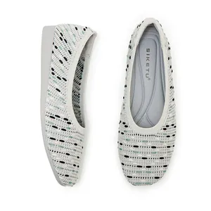 Close-up of gray knitted flat shoes for women with breathable woven texture