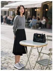 Outdoor lifestyle view of lightweight grey casual shoes with pleated skirt and sweater