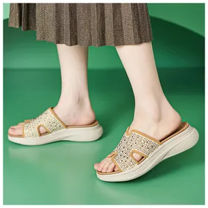 Detailopname van dames slippers met sleehak, strass H-band en geplooide rok