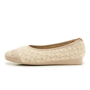 Macro detail of beige fly-knit ballet flat shoe with intricate perforated patterns