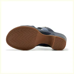 Macro shot of brown rubber outsole with wavy anti-slip patterns and size 36 mark