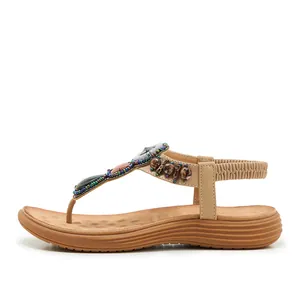 Detail view of Bohemian T-strap flat sandals with colorful beads and gemstones