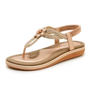 Detail of bohemian wedge sandals featuring rhinestone flower and elastic heel strap