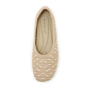 Detailed top view of beige knitted flats showing delicate texture and cushioned insole