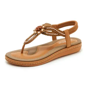 Detail of khaki bohemian sandals featuring rhinestones flower and elastic heel strap