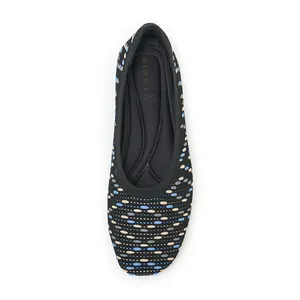 Top view of black knitted flat shoes with colorful oval dots and ergonomic insoles