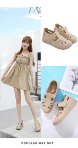 Detail of beige cutout wedge sandals with velcro straps and lightweight stitched soles
