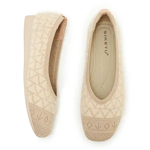 Close-up of beige knit ballet flats featuring geometric texture and plush inner sole
