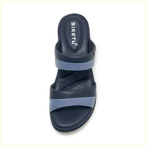 Detail view of cushioned footbed and navy blue leather straps on women wedge sandals