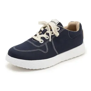 Detailed macro of navy blue canvas upper with contrast stitching and textured rubber sole