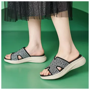 Detail van dames wedge slippers met grijs geometrisch breisel en dikke witte zool