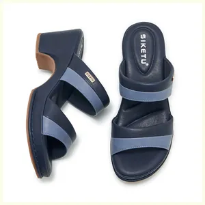 Detail view of women's wedge sandals in navy blue and light blue color block design