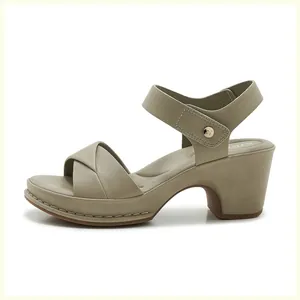Detail of comfortable block heel sandal with stitching and gold metal logo