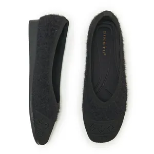 Detailed top and side view of black fuzzy knit loafers with quilted texture on the toe