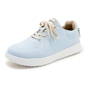 Detail of light blue casual sneakers featuring thick white non-slip rubber soles and laces