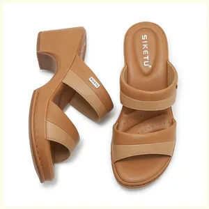 Detail view of brown patchwork wedge sandals featuring double straps and cushioned insoles