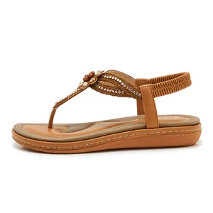 Detailed view of bohemian sandals with rhinestone flowers and elastic heel strap