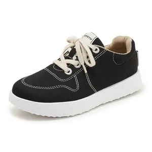Close-up of black canvas casual shoes with white stitching and textured non-slip sole