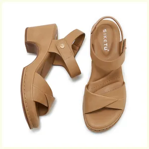 Detail of cross-strap sandals with decorative stitching and thick comfortable sole