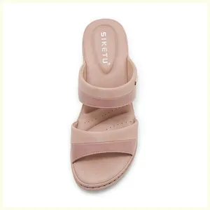 Close-up detail of ergonomic arch support footbed and stitching on pink block heel sandals