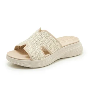 Macro-opname van beige plateausandalen met strassteentjes H-band en sleehak voor dames